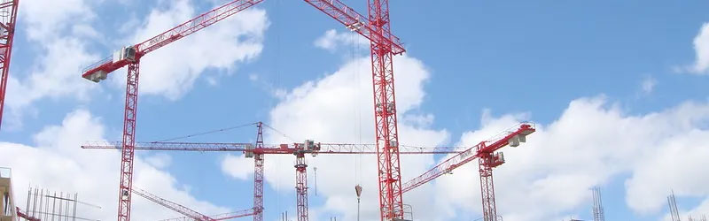 Construction cranes in a skyline