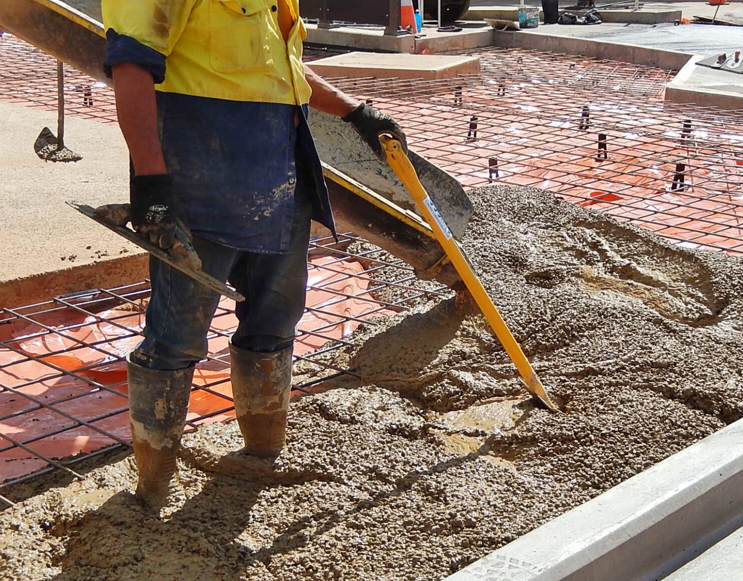 Construction worker pouring concrete
